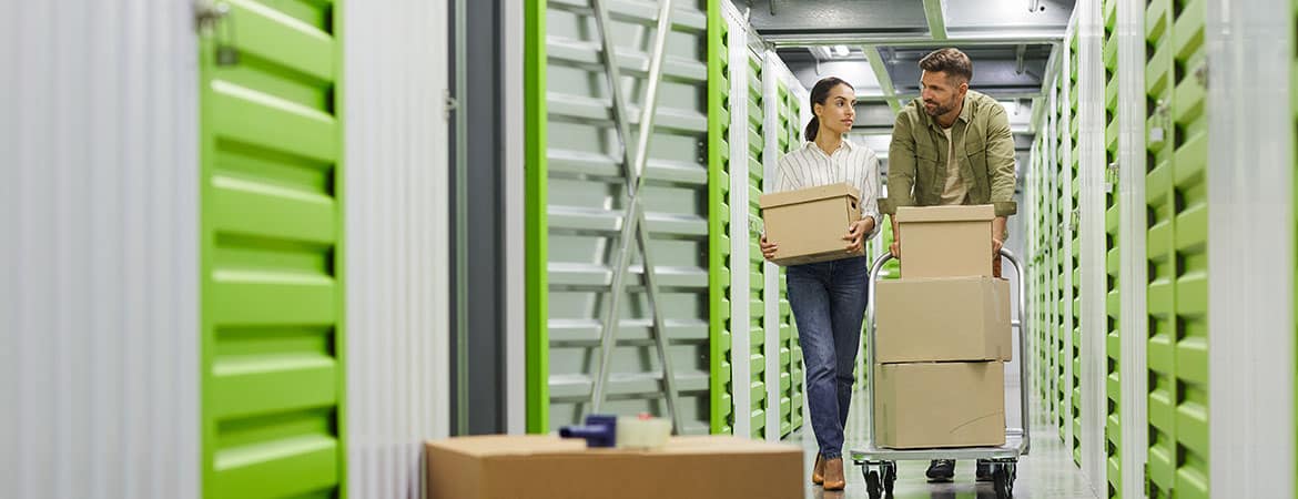 Couple moving boxes in Storage Unit | Lakeside Storage in Leesburg, FL