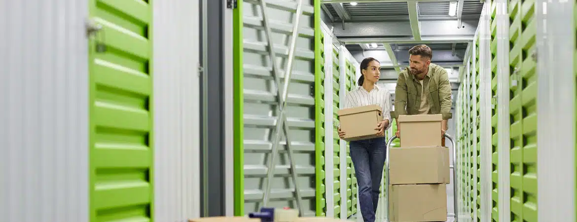 Couple moving boxes in storage unit