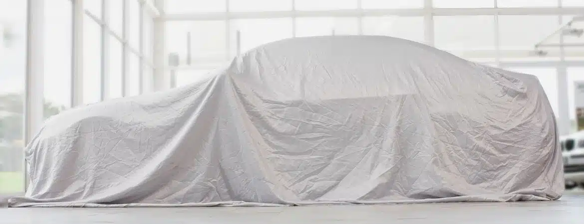 Car covered in cloth in garage